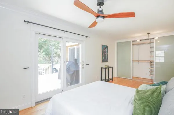 a bedroom with a bed dresser and a window