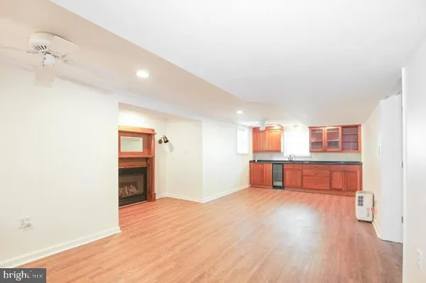 a view of a room with wooden floor and a cabinet