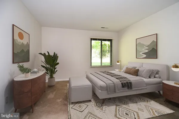 a bedroom with a bed and a couch