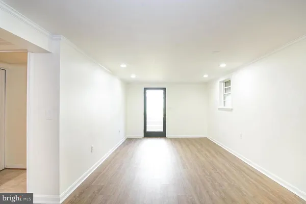 a view of an empty room with wooden floor