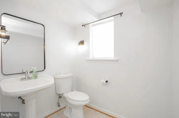 a bathroom with a sink toilet and a mirror