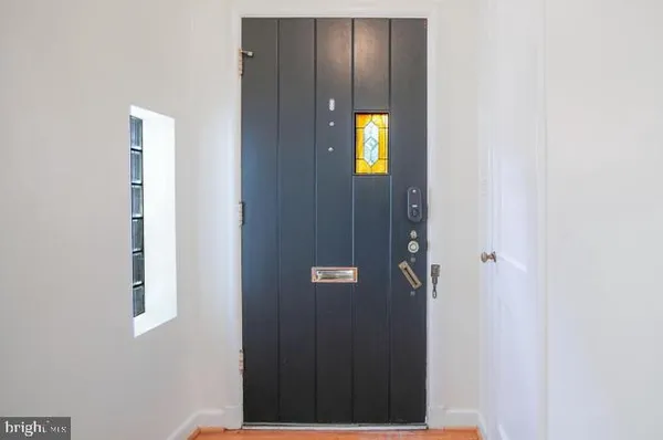 a view of an entryway with wooden floor