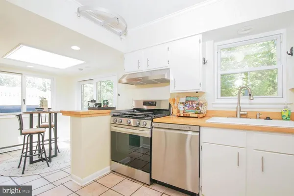 a kitchen with a stove a sink and a refrigerator