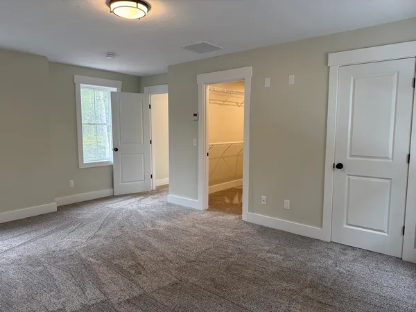 an empty room with windows and closet