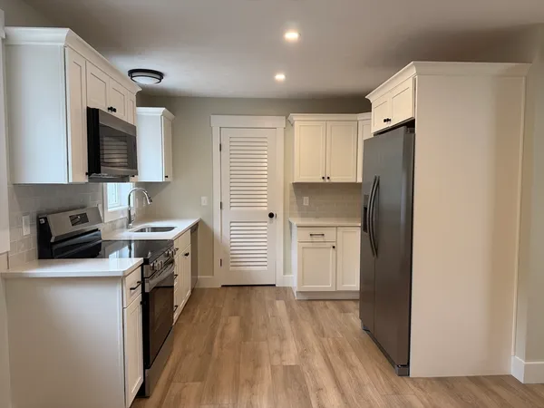a kitchen with a refrigerator stove and sink