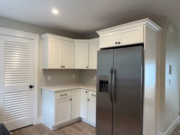 a kitchen with cabinets and stainless steel appliances