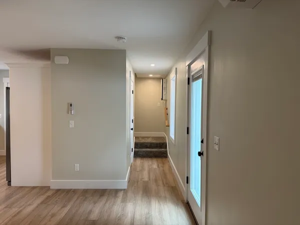 a view of a hallway with wooden floor