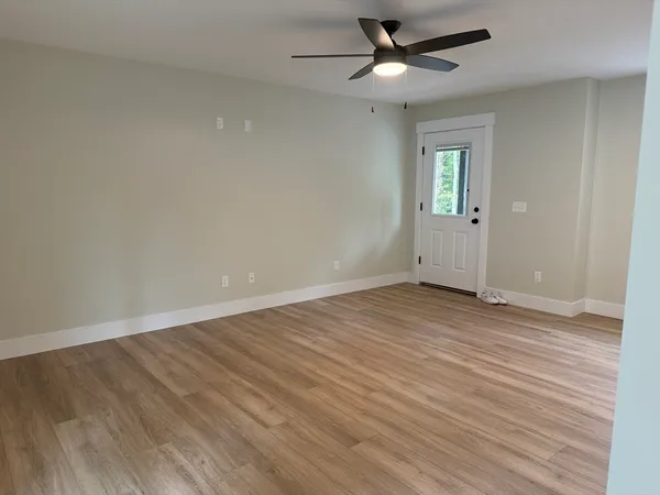 wooden floor in an empty room with a window