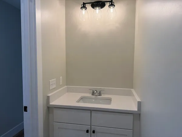 a bathroom with a sink and cabinets