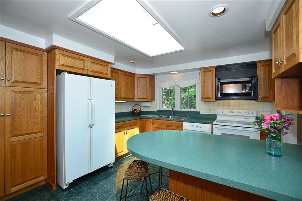 9372 Hilliard Road Pittsburgh, PA 15237 - Photo 6 of 24 Solid custom built cabinetry with island and 4 pantry cabinets. Skylight illuminates the kitchen.