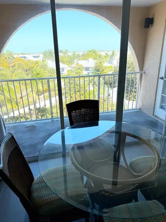 a living room with table or chairs and a floor to ceiling window