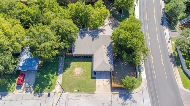 an aerial view of a house with a yard
