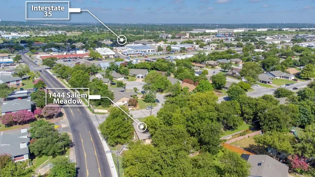 an aerial view of a house with a yard and garden