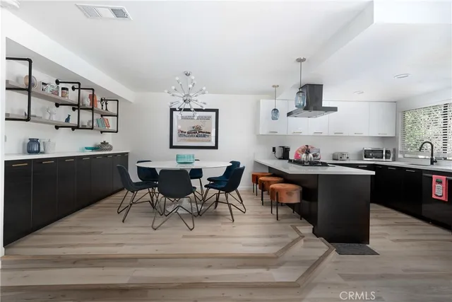a kitchen with a table chairs and a refrigerator