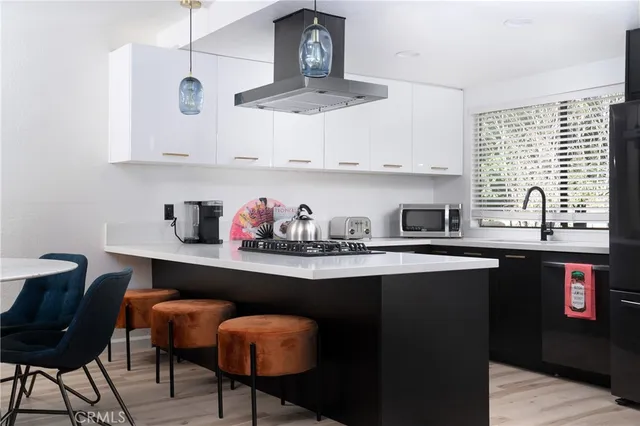 a kitchen with stainless steel appliances a sink and cabinets