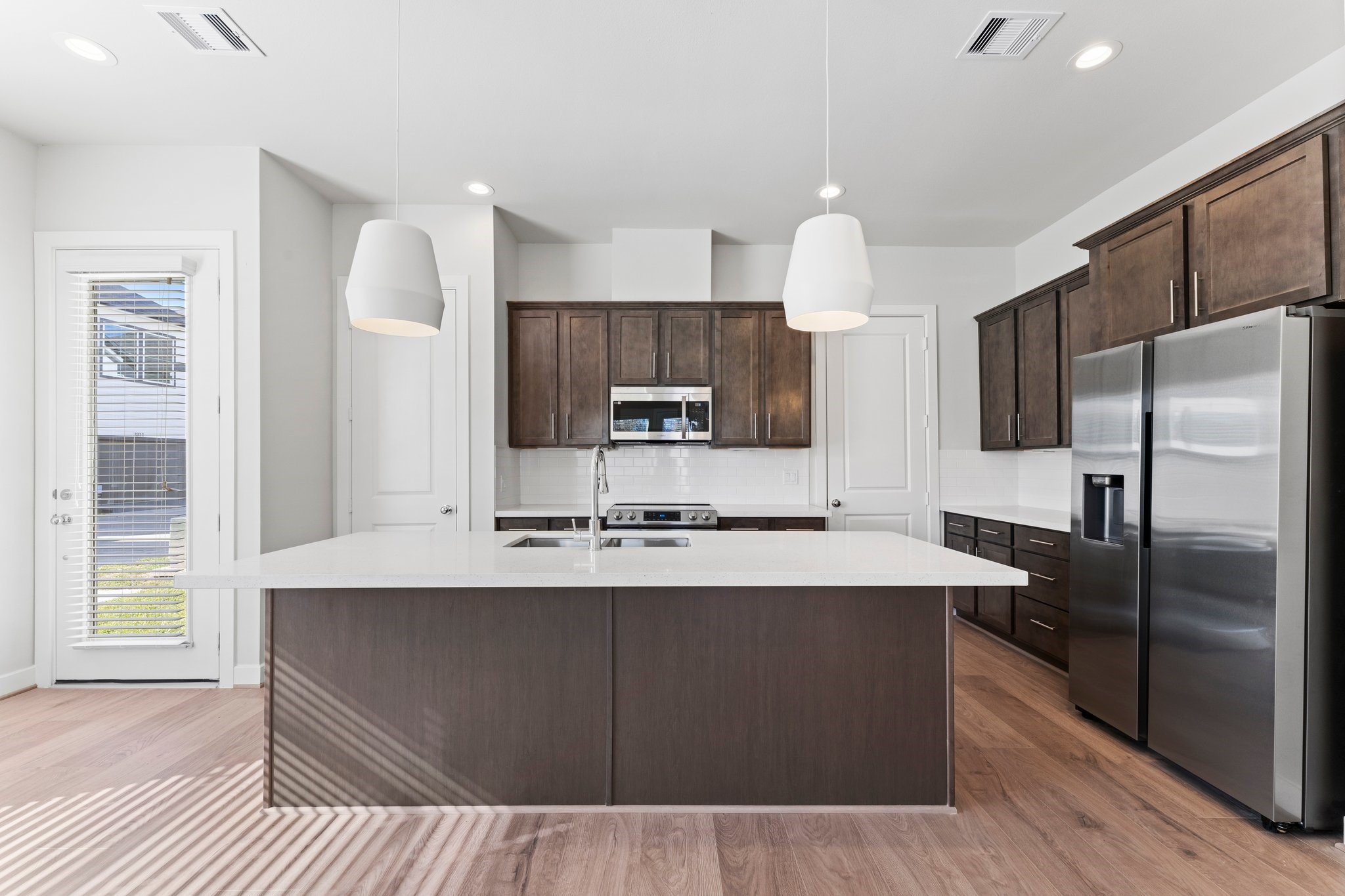 5904 Jasper Jones Way Houston, TX 77091 - Photo 12 of 37 a kitchen with kitchen island a sink stainless steel appliances and cabinets