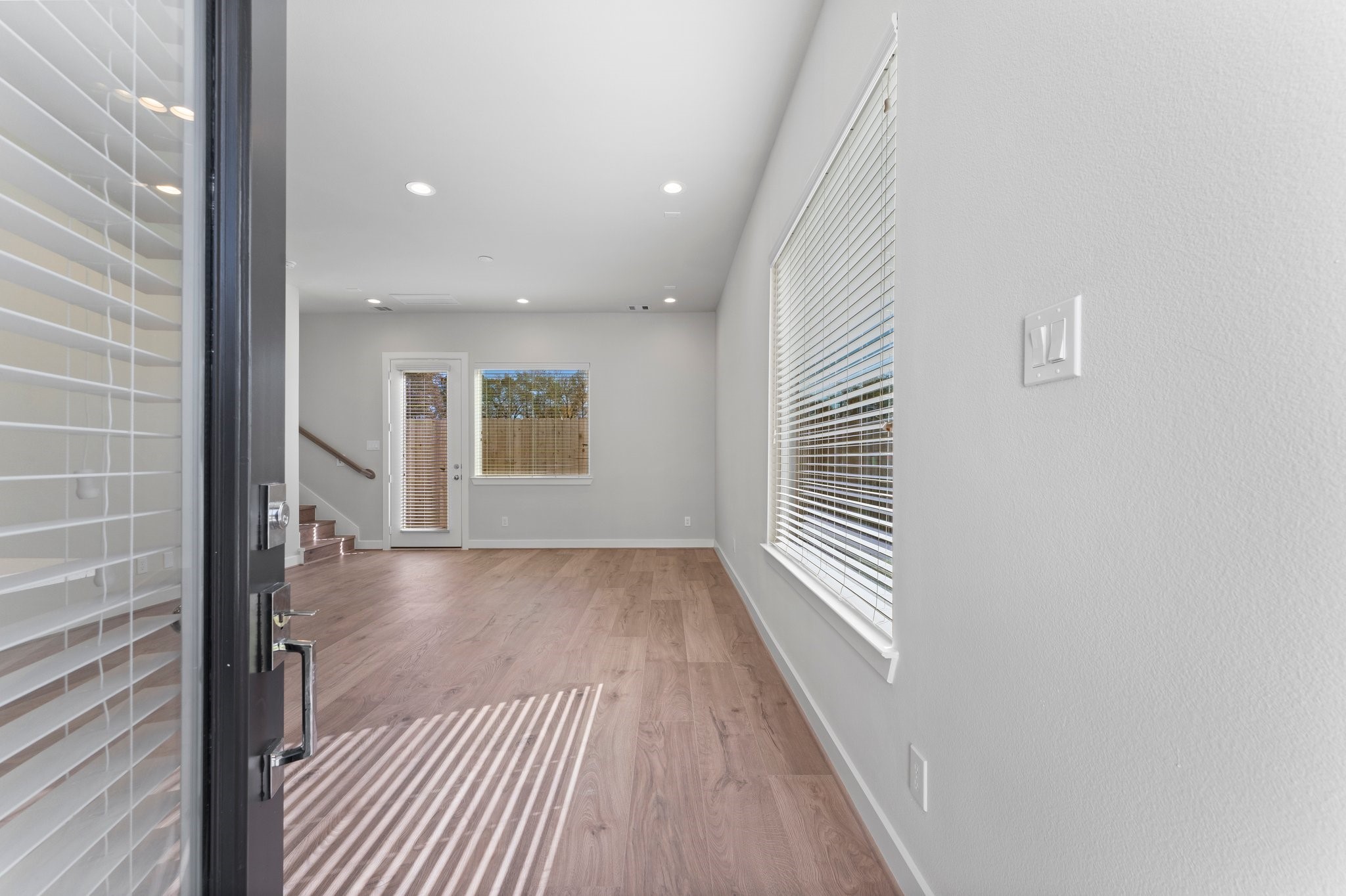 5904 Jasper Jones Way Houston, TX 77091 - Photo 2 of 37 a view of a hallway with wooden floor and staircase