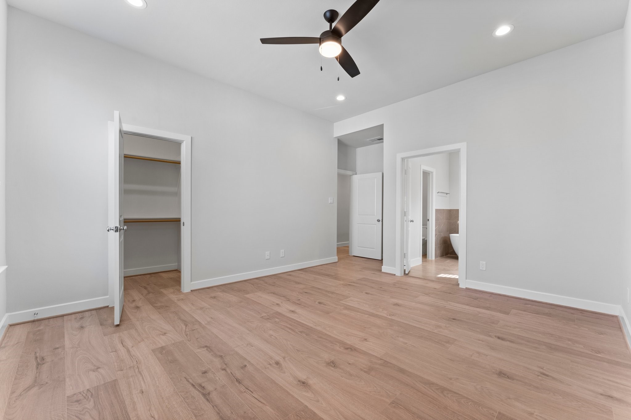 5904 Jasper Jones Way Houston, TX 77091 - Photo 23 of 37 an empty room with wooden floor and ceiling fan