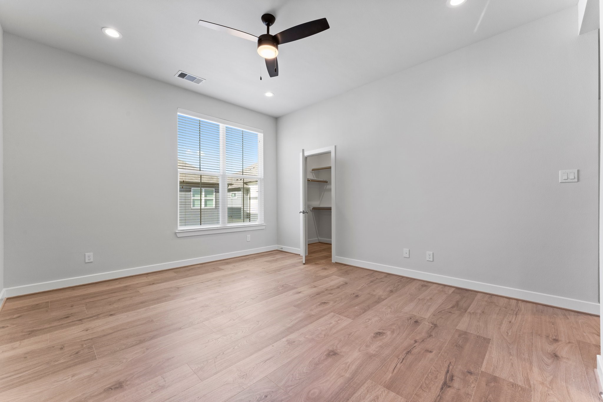5904 Jasper Jones Way Houston, TX 77091 - Photo 24 of 37 a view of an empty room with a window and wooden floor