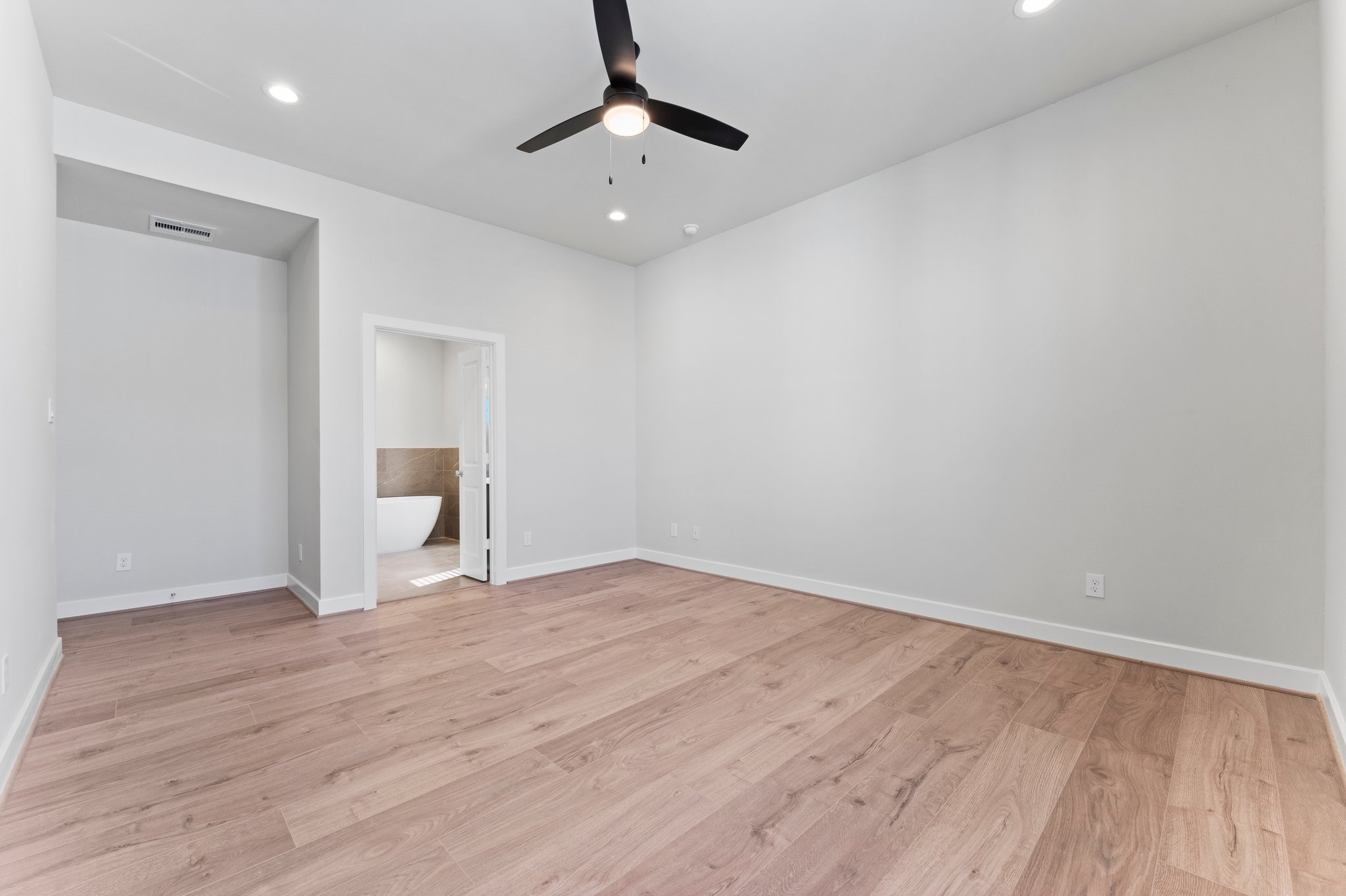 5904 Jasper Jones Way Houston, TX 77091 - Photo 25 of 37 a view of an empty room with wooden floor and a window