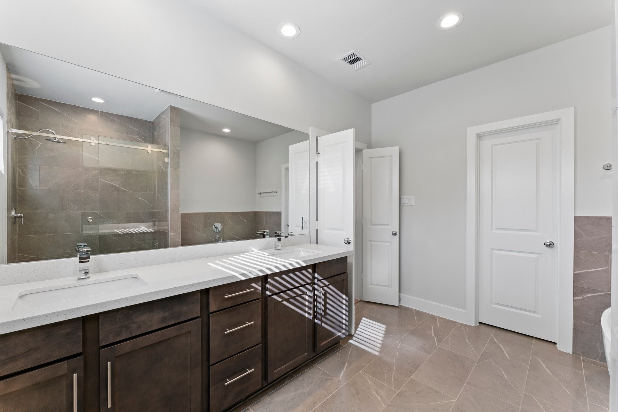 5904 Jasper Jones Way Houston, TX 77091 - Photo 27 of 37 a spacious bathroom with a double vanity sink and a mirror