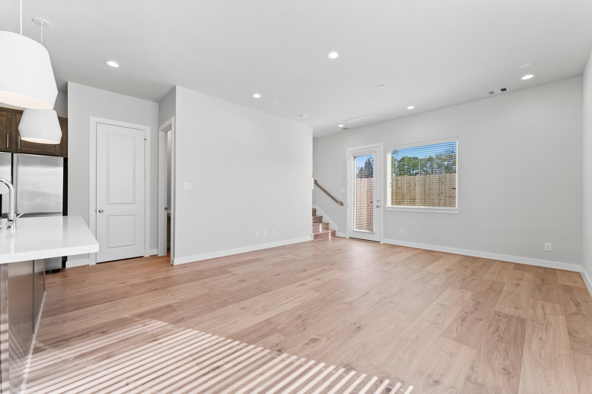 5904 Jasper Jones Way Houston, TX 77091 - Photo 3 of 37 a view of an empty room with wooden floor and a window