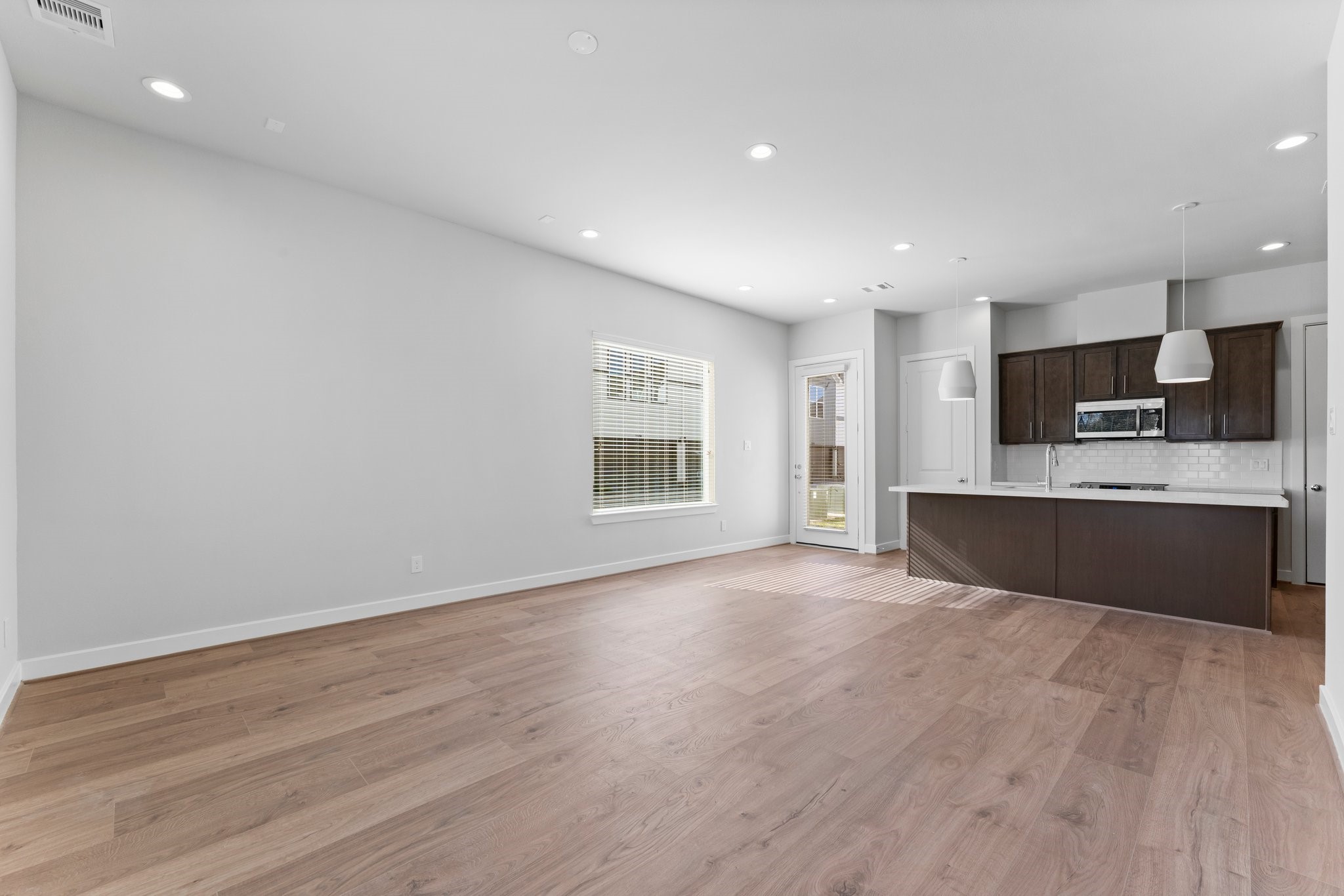 5904 Jasper Jones Way Houston, TX 77091 - Photo 5 of 37 a large kitchen with stainless steel appliances granite countertop a large counter top and a wooden floor