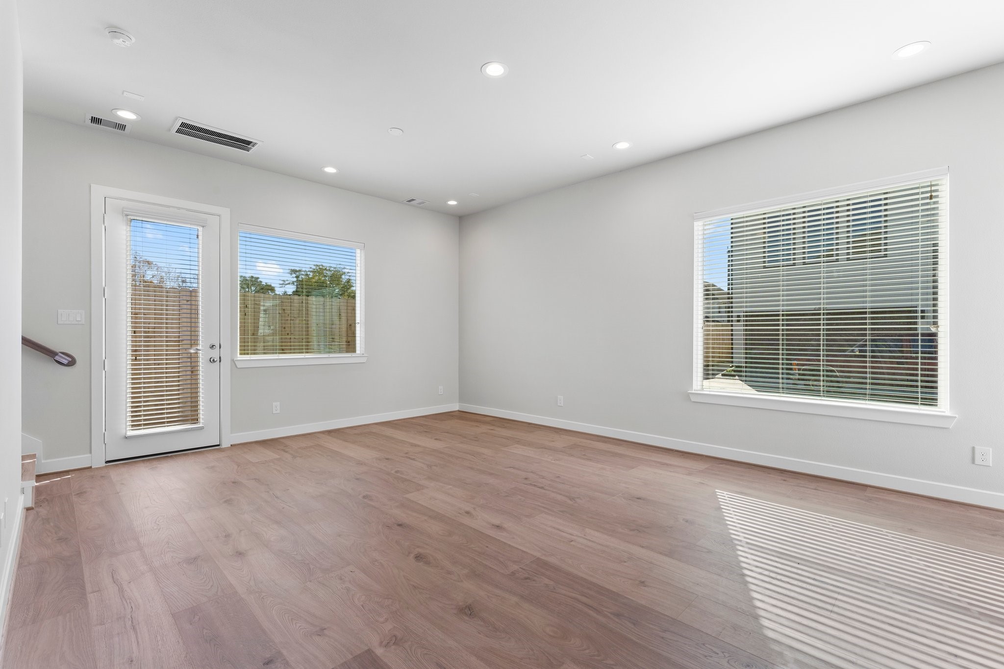 5904 Jasper Jones Way Houston, TX 77091 - Photo 6 of 37 an empty room with wooden floor and windows