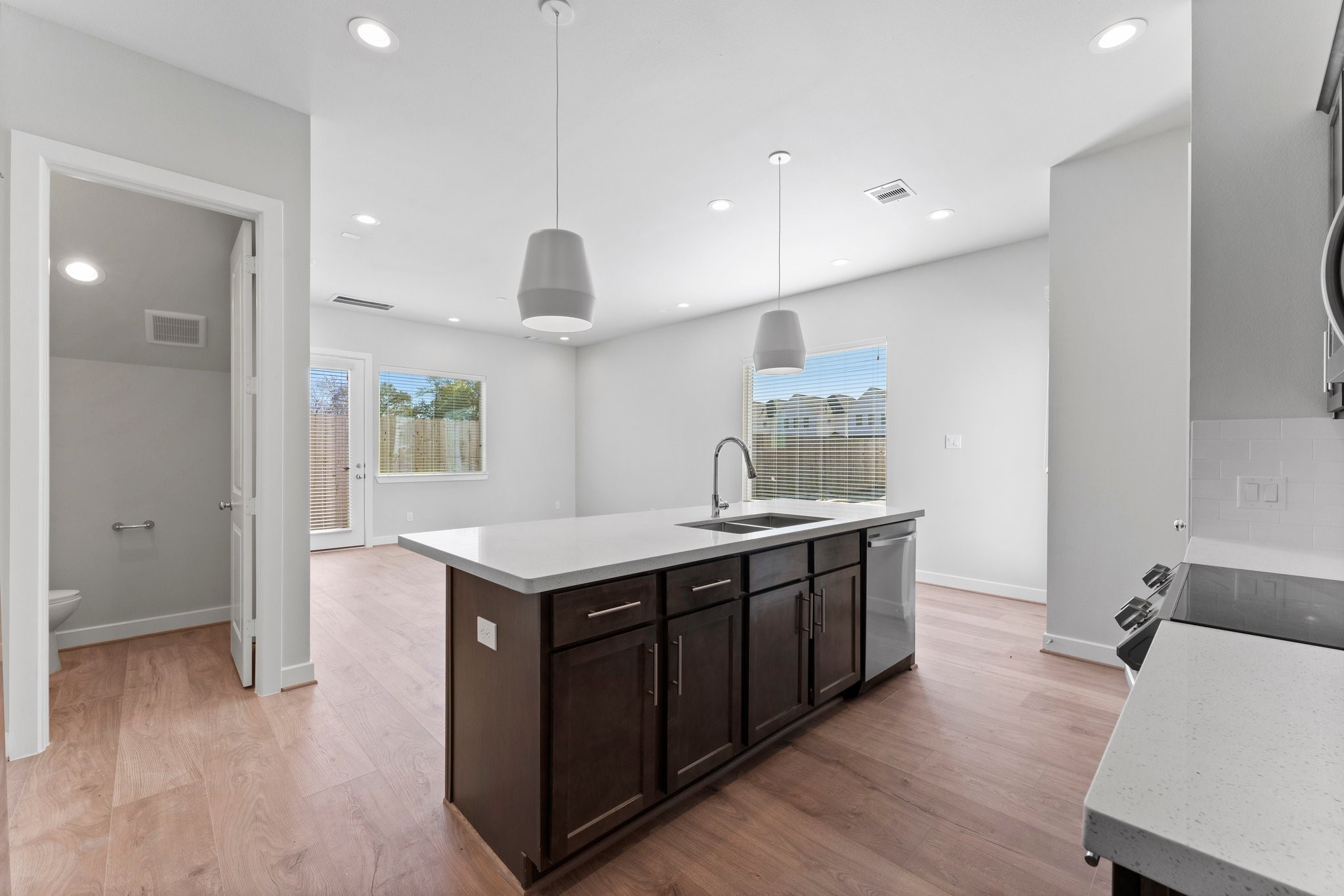 5904 Jasper Jones Way Houston, TX 77091 - Photo 8 of 37 a kitchen with stainless steel appliances granite countertop a sink a stove and a wooden floors