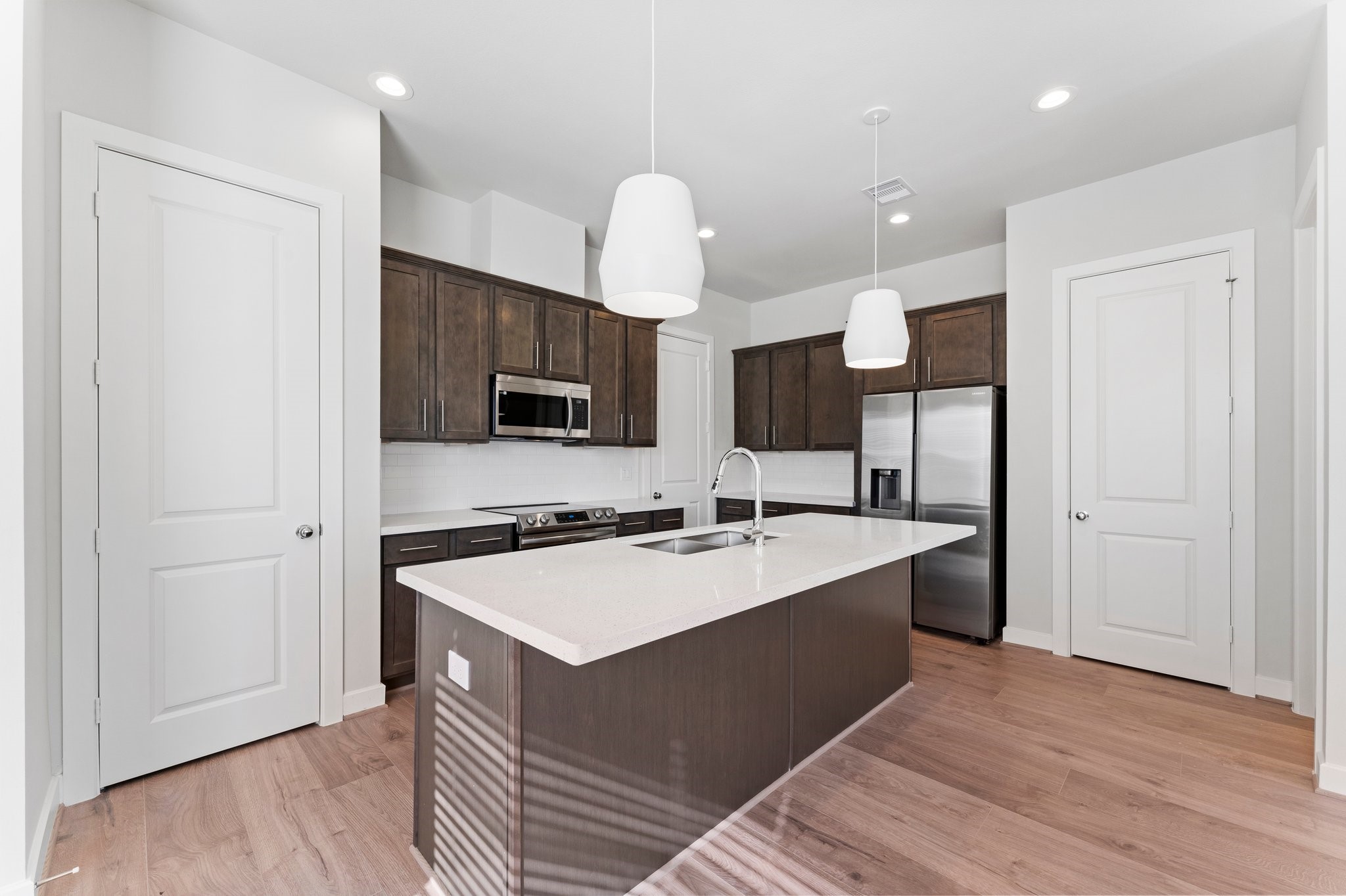 5904 Jasper Jones Way Houston, TX 77091 - Photo 10 of 37 a large kitchen with kitchen island a sink stainless steel appliances and cabinets
