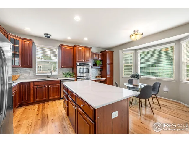 a kitchen with a sink cabinets and wooden floor