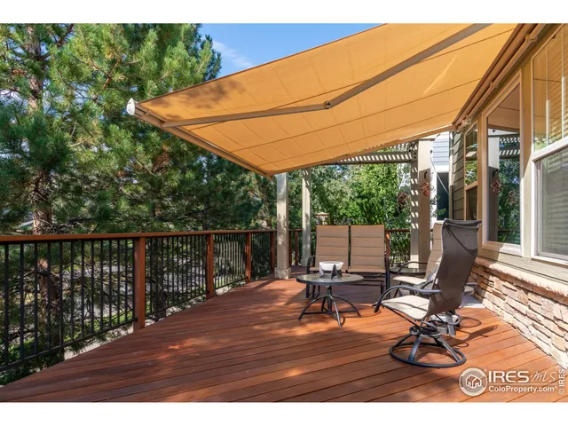 a view of balcony with wooden floor and outdoor seating