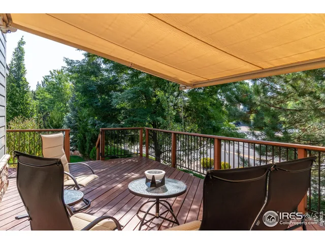 a view of a deck with a table and chairs