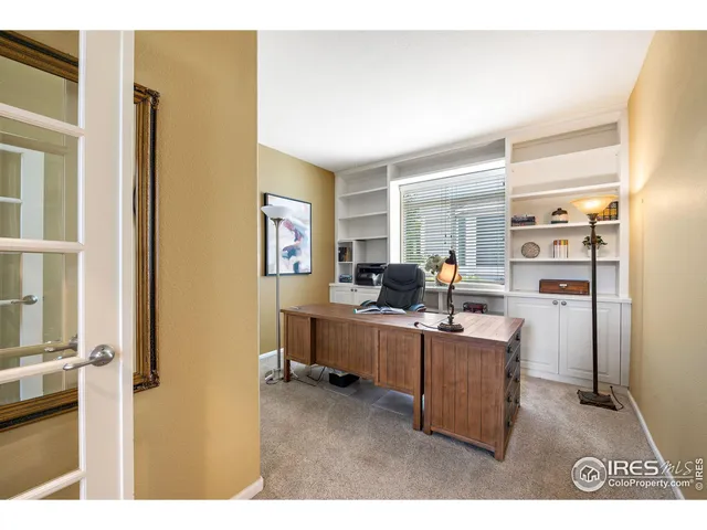 a view of a kitchen with cabinets and wooden floor