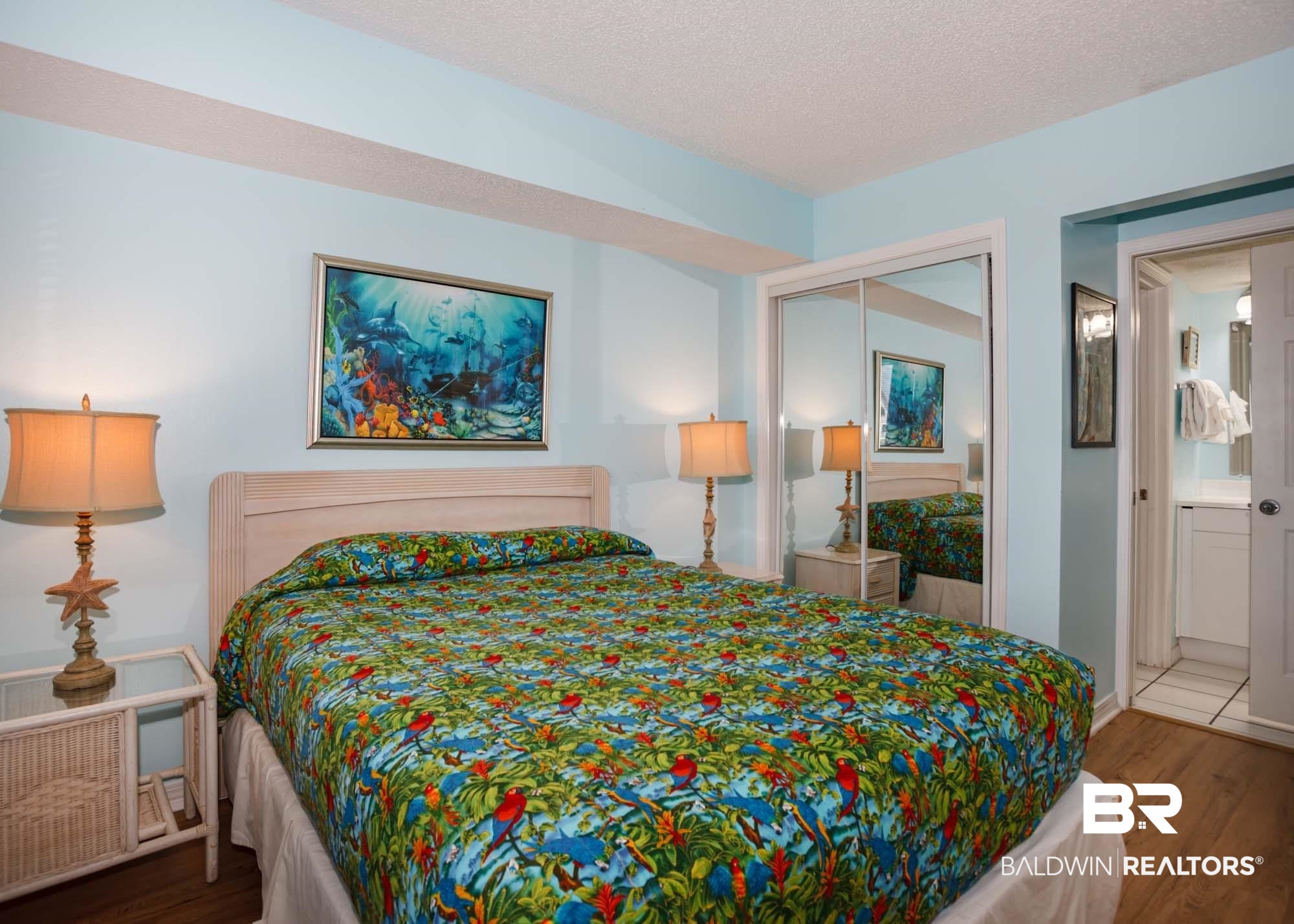645 Plantation Road, Unit 6311 Gulf Shores, AL 36542 - Photo 12 of 43 Bedroom with wood finished floors, ensuite bath, a closet, and a textured ceiling