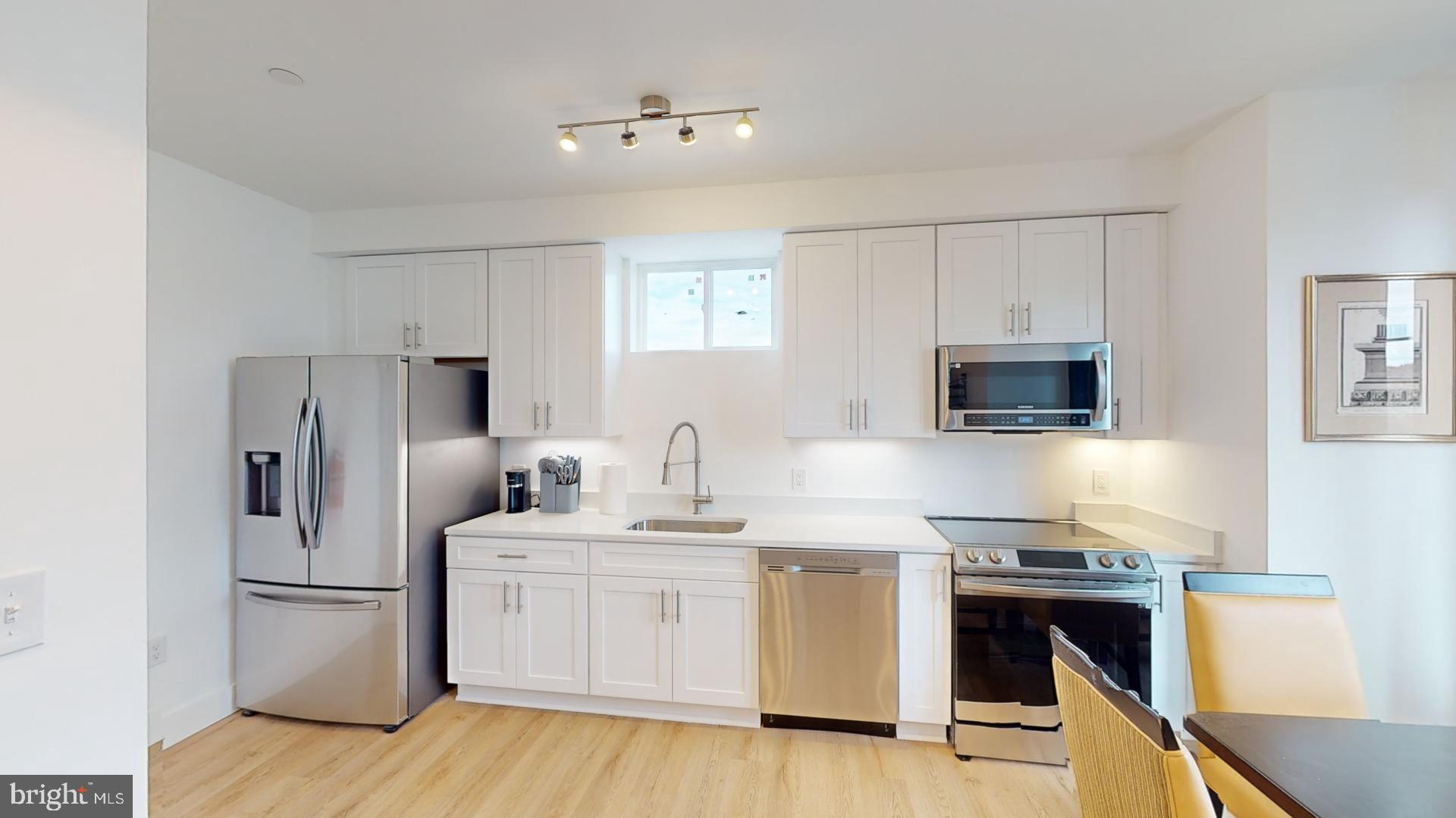 201 Kennedy Street Northwest, Unit 8 Washington, DC 20011 - Photo 2 of 14 a kitchen with stainless steel appliances a refrigerator stove and microwave