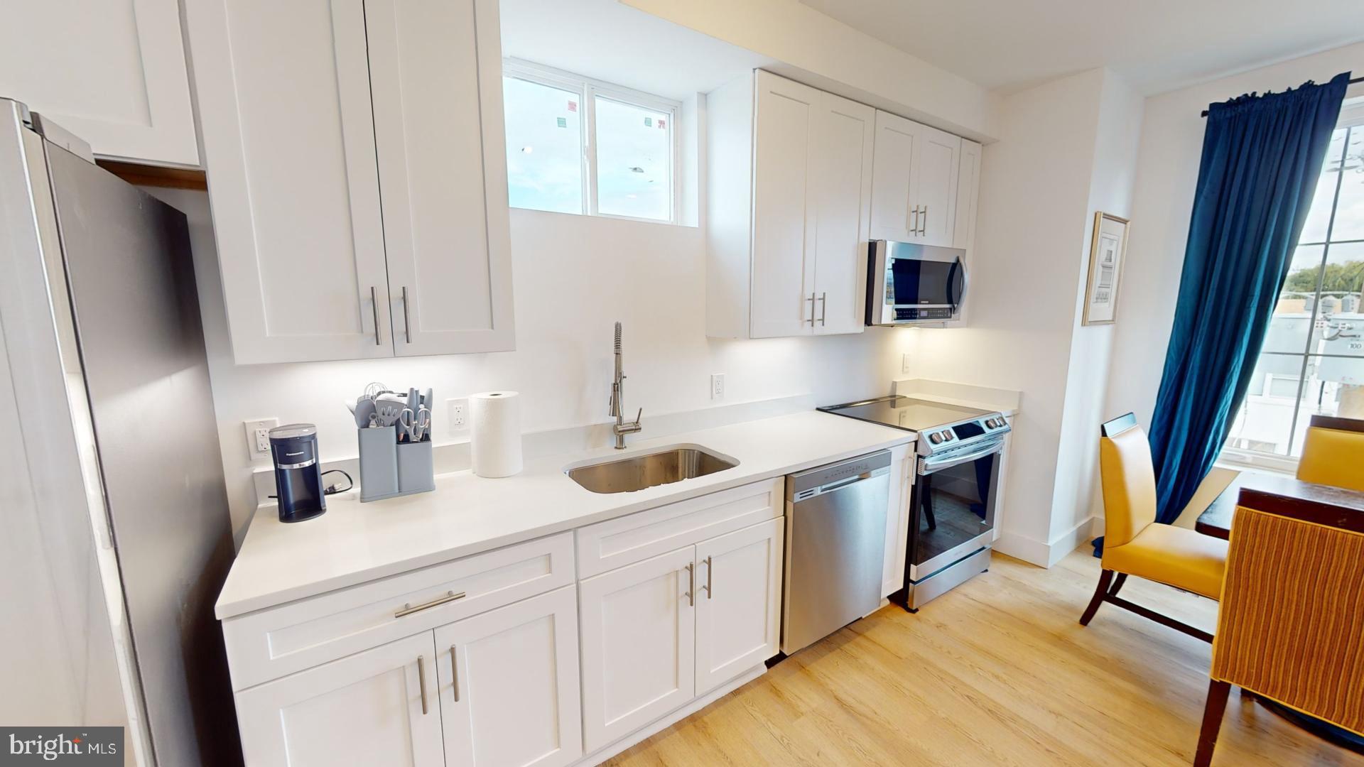 201 Kennedy Street Northwest, Unit 8 Washington, DC 20011 - Photo 3 of 14 a kitchen with white cabinets and sink