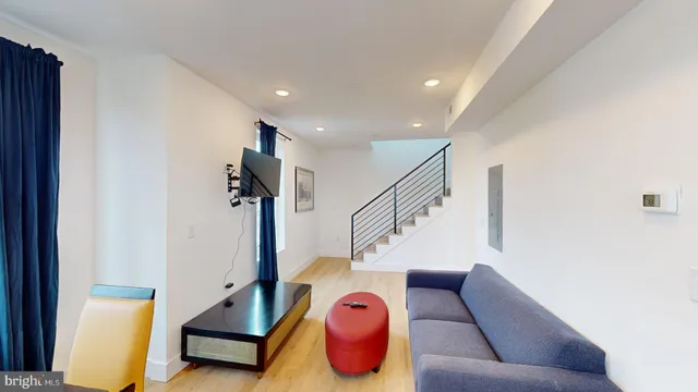 a living room with furniture and stairs