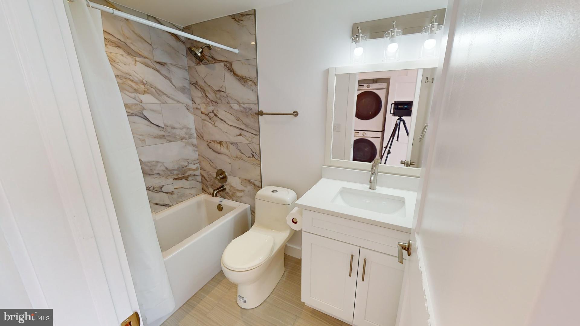 201 Kennedy Street Northwest, Unit 8 Washington, DC 20011 - Photo 9 of 14 a bathroom with a sink a toilet and shower