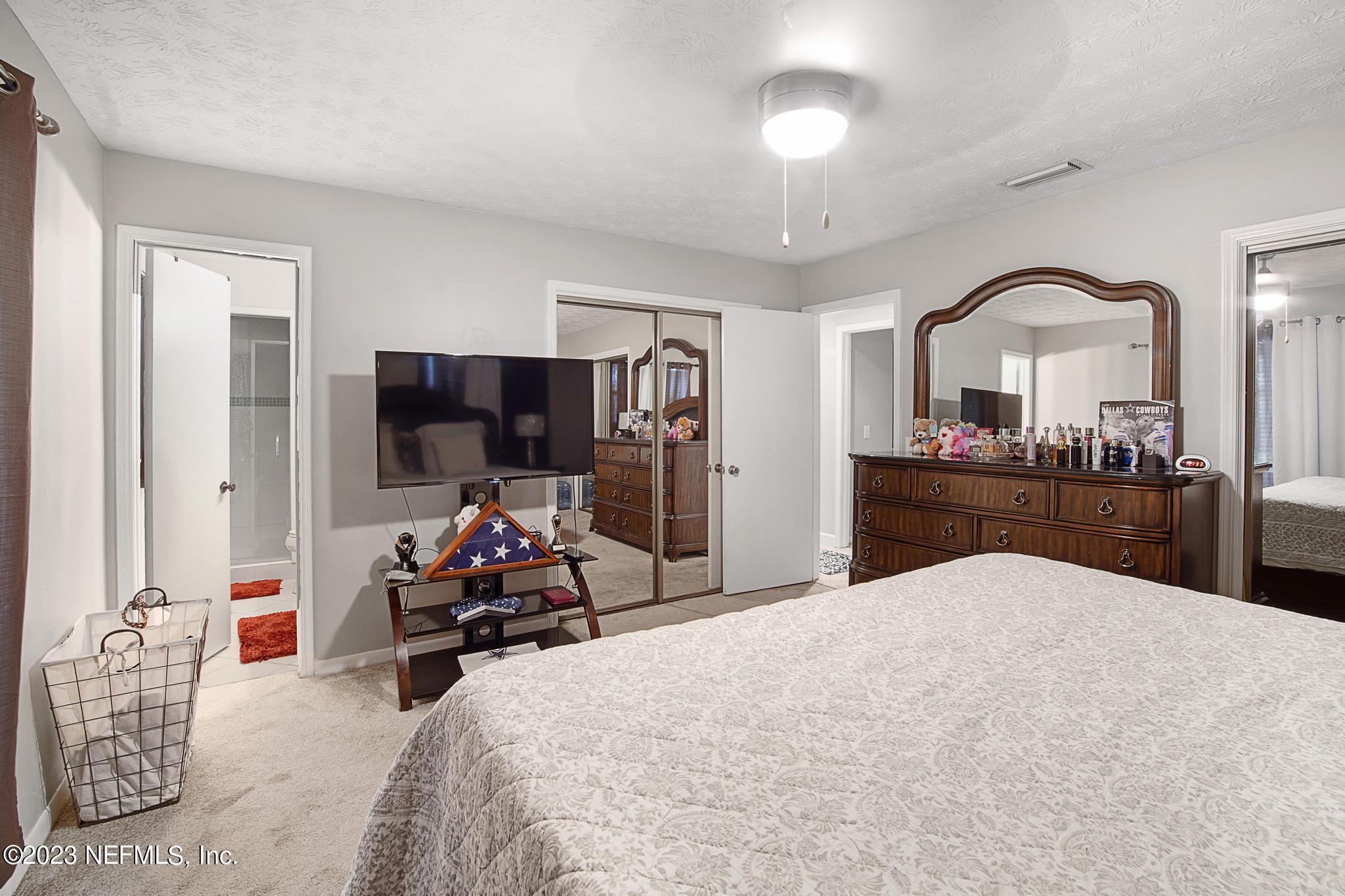 2411 Aquarius Road Orange Park, FL 32073 - Photo 17 of 24 a living room with furniture and a flat screen tv