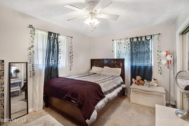 a bedroom with a bed couch and a window