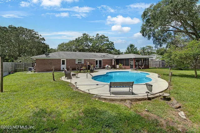 aerial view of a house with swimming pool and sitting area