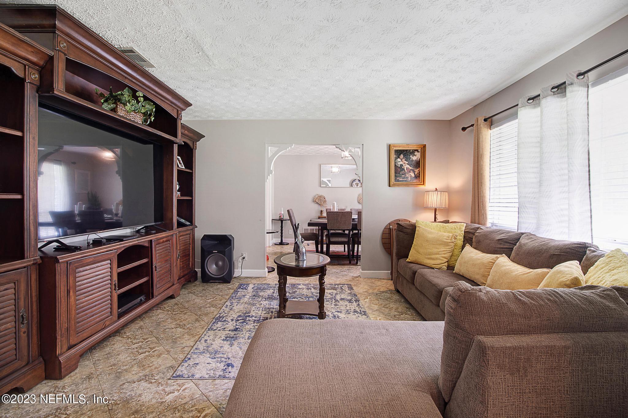 2411 Aquarius Road Orange Park, FL 32073 - Photo 5 of 24 a living room with furniture and a flat screen tv