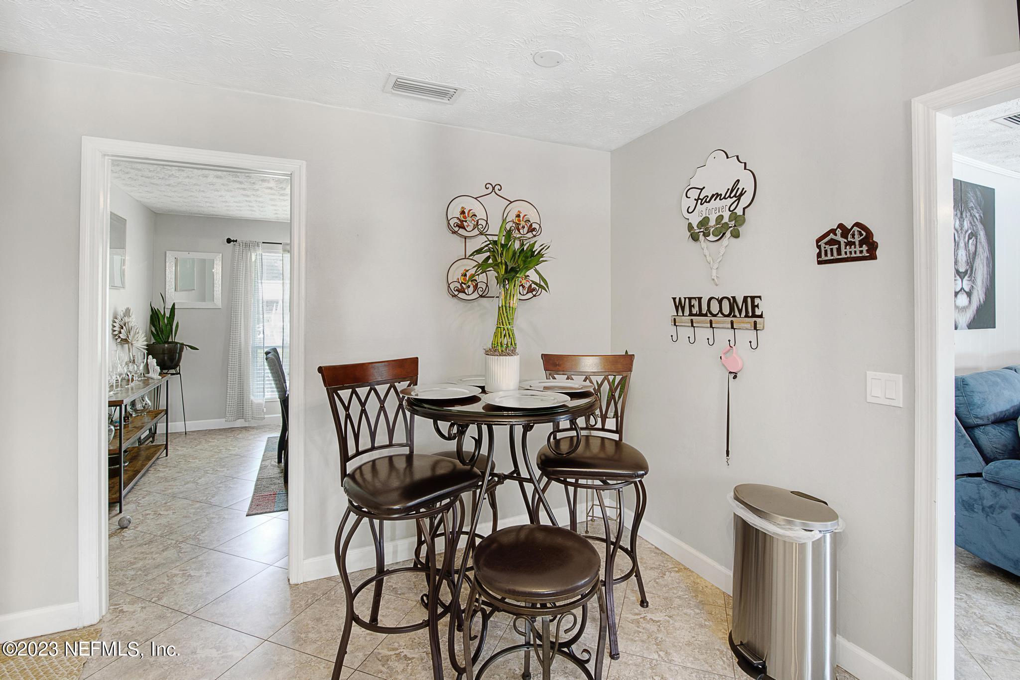 2411 Aquarius Road Orange Park, FL 32073 - Photo 7 of 24 a view of a dining room with furniture and wooden floor
