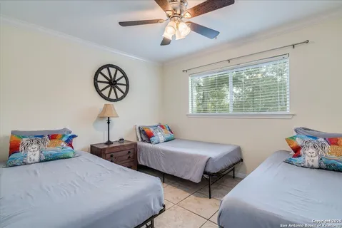 a bedroom with two beds and a chandelier