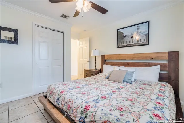 a bedroom with a large bed and a chandelier