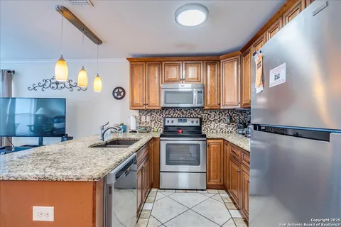 a kitchen with a sink a stove and cabinets