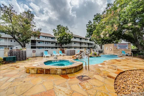 a swimming pool with outdoor seating and yard