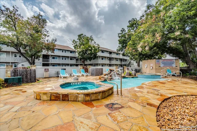 a swimming pool with outdoor seating and yard