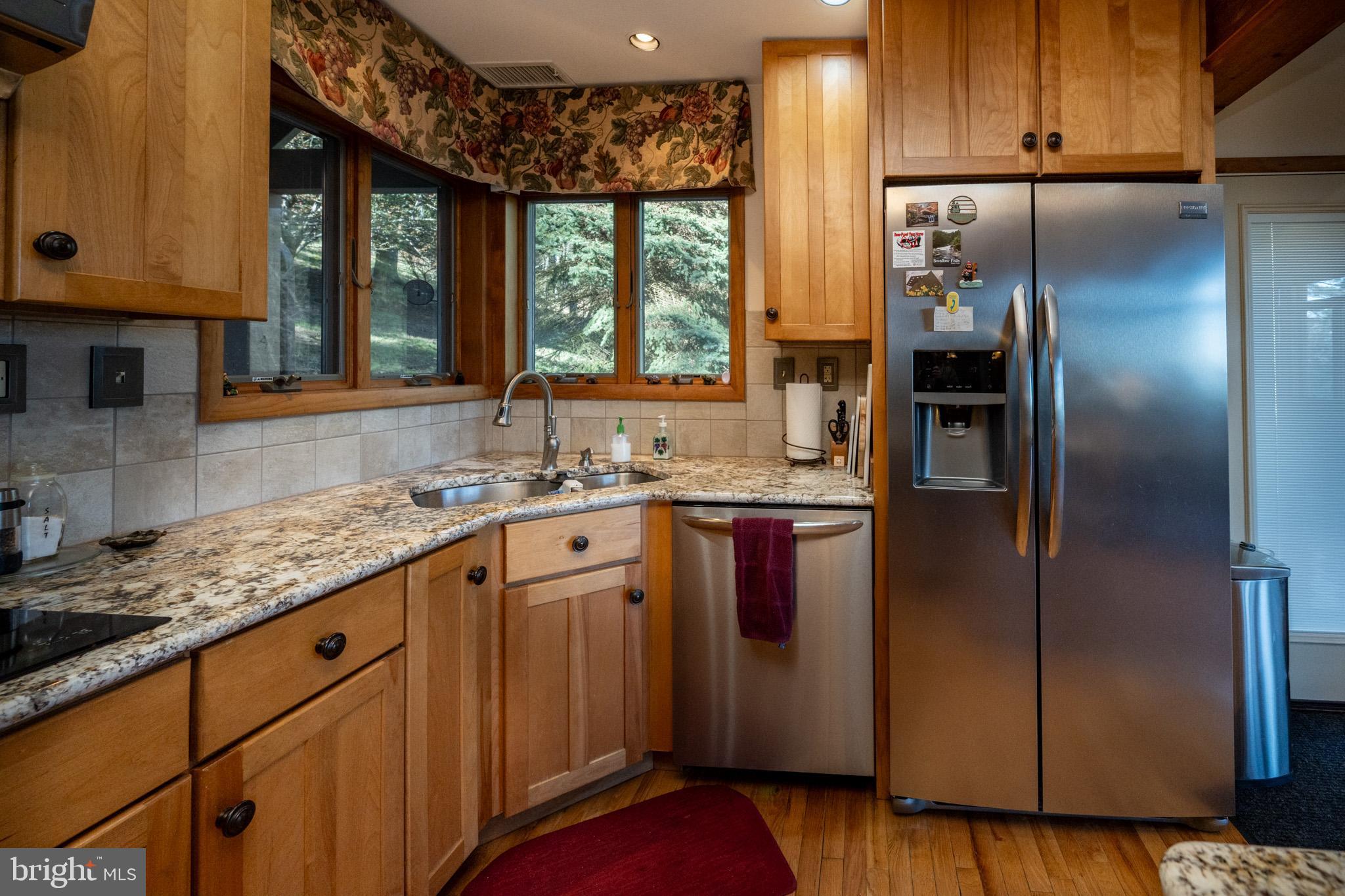 59 Glenview Road Swanton, MD 21561 - Photo 16 of 85 a kitchen with stainless steel appliances granite countertop a refrigerator and a sink